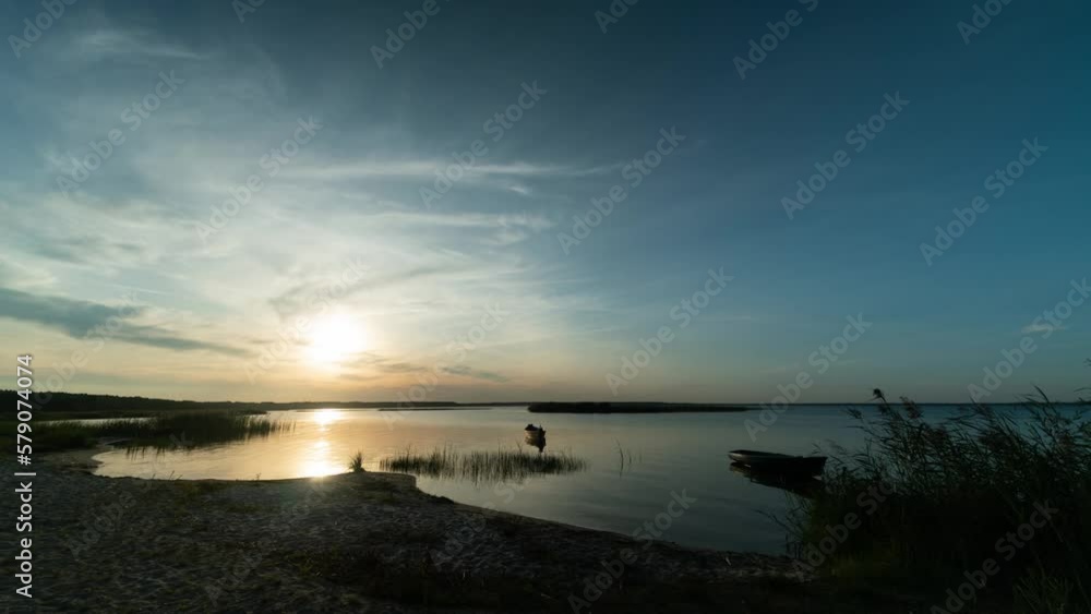 Timelapse of the sunset in the sky with clouds on the beach with fishing boats of Lake Svityaz in Ukraine. Timelapse of the sunset in the sky with clouds on the beach with fishing boats of Lake Svityaz in Ukraine.