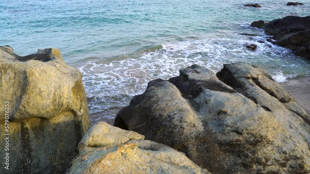 Large stones on the ocean at sunrise Large stones on the ocean at sunrise
