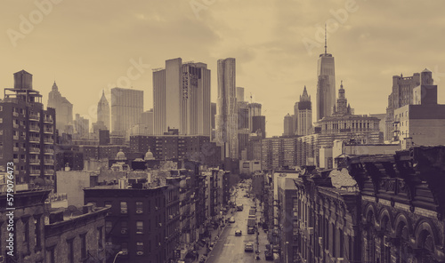 New York City overhead view of Madison Street in Chinatown and the downtown skyline buildings with faded sepia color effect © deberarr