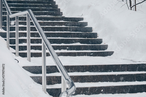 Granite steps in winter covered with snow