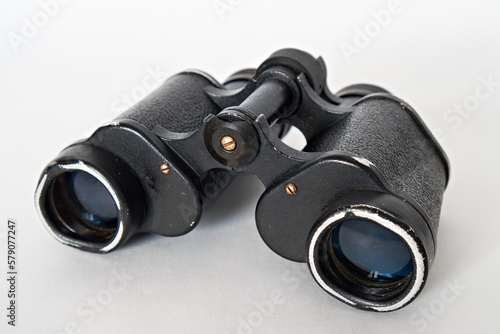 Black vintage binoculars isolated on white background. Close-up