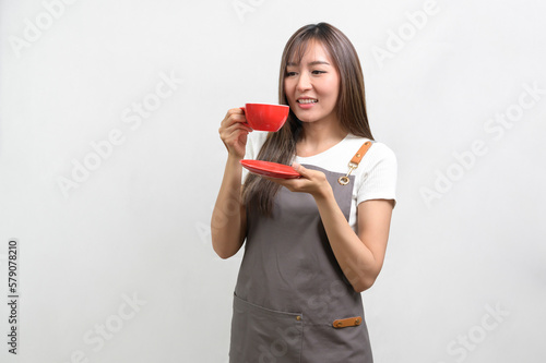Portrait of young asian woman wearing apron over white background studio, cooking and entrepreneur concept.