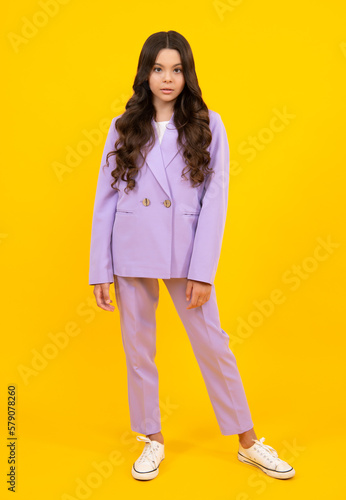 Full length photo of pretty teenager child girl wear casual clothes isolated on yellow background.
