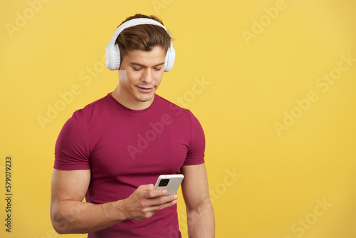 Relaxed man listening to music with the mobile and headphones © Iván Moreno