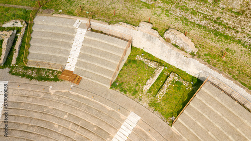 Aerial view of the ancient remains of a Roman theater. The archaeological site is located in Tivoli, near Rome, Italy. Aerial closeup. photo