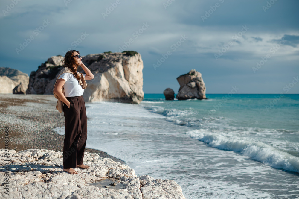 Attractive woman in summer clothes dancing on the beach Attractive woman in summer clothes dancing on the beach