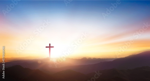 Slika na platnu Silhouette of crucifix cross on mountain at sunset sky background