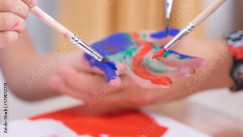 Hands little the girl painted colorful happy watercolor artist for child's hands background White paper.