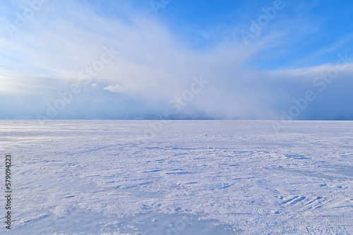 Beautiful Scenery of Frozen Lake Baikal Covered with Snow During Snowstorm © panithi33