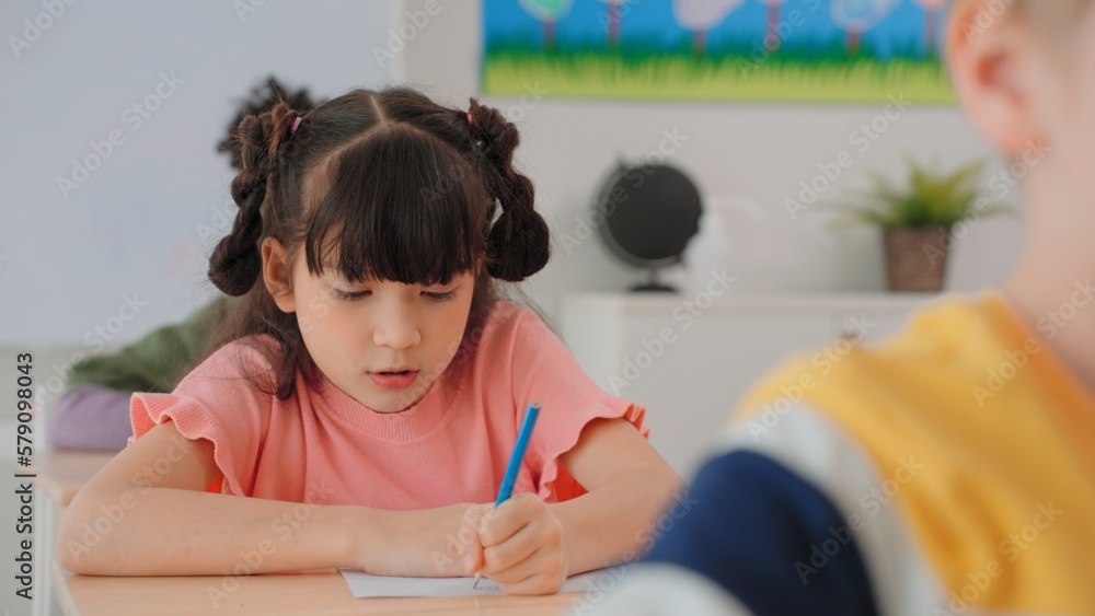 Elementary school students girl are stressing about doing their final exams in the exam room at school Elementary school students girl are stressing about doing their final exams in the exam room at school