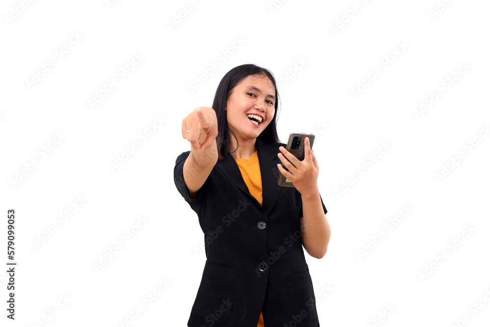 Happy young asian business woman pointing on camera while holding a cell phone. Isolated on white Happy young asian business woman pointing on camera while holding a cell phone. Isolated on white