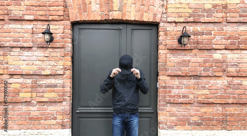 Wallpaper Mural Young man standing near the front door of a brick house Torontodigital.ca