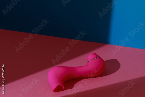 Sex toy for women also called vacuum clitoral stimulator for satisfaction on pink background 