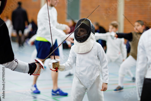 Photography Little kid boy fencing on a fence competition