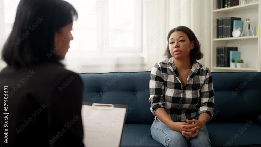 Upset black woman talking with psychotherapist about her problems, mental health Upset black woman talking with psychotherapist about her problems, mental health