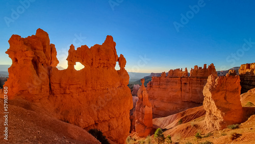 Scenic sunrise view on rock formation on Navajo Rim trail in Bryce Canyon National Park, Utah, USA. Scenic golden hour view of sun star shinning through Sandstone Hoodoos in Bryce Canyon Amphitheatre