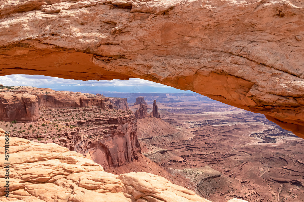 Scenic view through Mesa Arch near Moab, Canyonlands National Park, San Juan County, Southern Utah, USA. Looking at natural pothole arch rock formation on the eastern edge of Island in the Sky Mesa