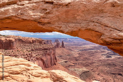 Scenic view through Mesa Arch near Moab, Canyonlands National Park, San Juan County, Southern Utah, USA. Looking at natural pothole arch rock formation on the eastern edge of Island in the Sky Mesa