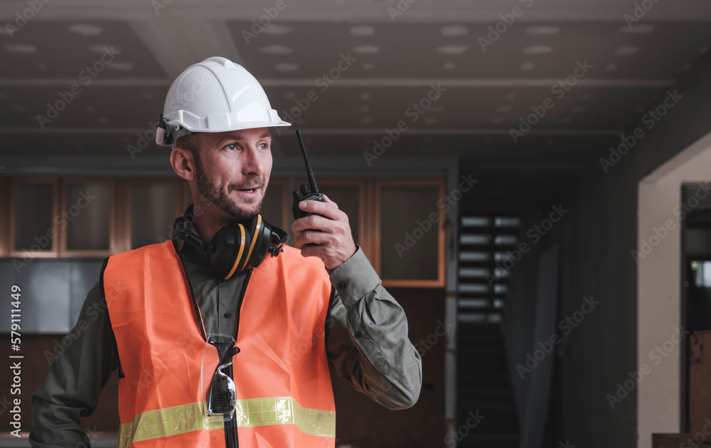 Leadership Concept by male Engineers : Portrait of a happy male engineer in front of a group of male construction workers : Effective teamwork Leadership Concept by male Engineers : Portrait of a happy male engineer in front of a group of male construction workers : Effective teamwork