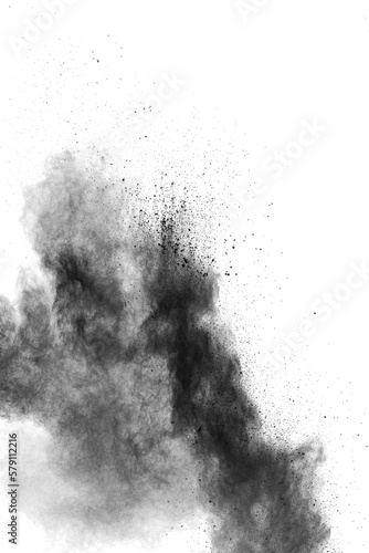 Black powder dust splashing.Black particles splattered on white background.