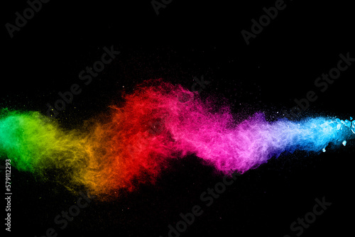 Abstract colorful powder explosion on black background.Freeze motion of dust splash.Painted Holi.