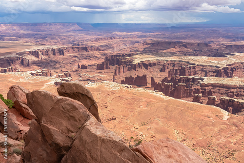 Scenic view on Split Mountain Canyon seen from Grand View Point Overlook near Moab, Island in the Sky District, Canyonlands National Park, San Juan County, Utah, USA. Dark clouds accumulating to storm photo