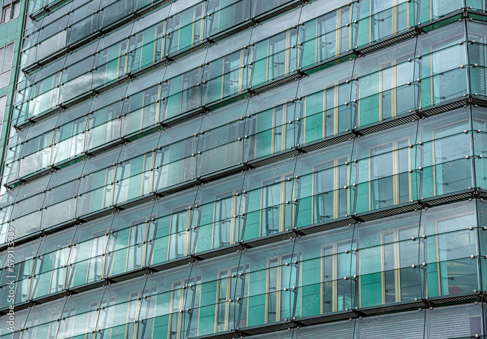 Obraz premium The wall of glass windows of a building.