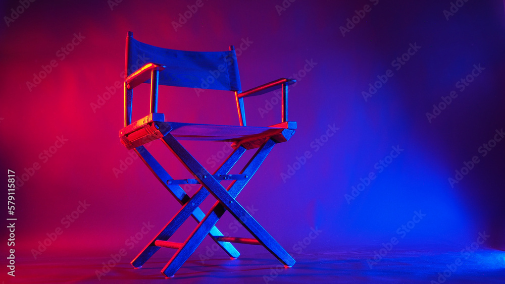 Black Director chair in red and blue light color with black background Black Director chair in red and blue light color with black background