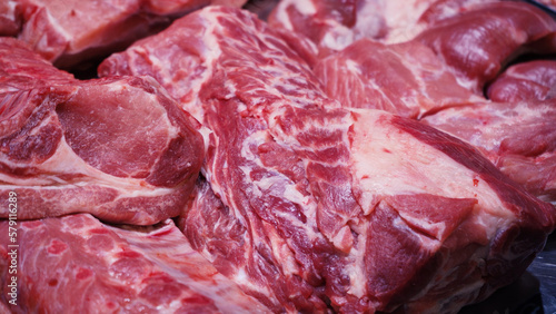 Meat shop. A wide selection of meat products in the supermarket. Fresh meat in a showcase. Fresh raw meat in a showcase.