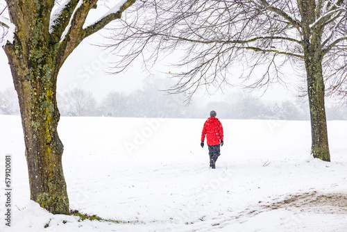 A man walks across a snow covered field © Chris Sharp
