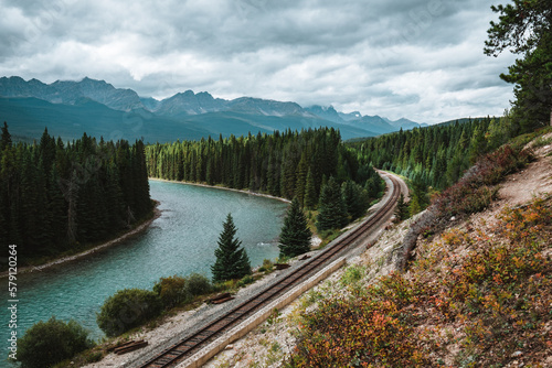 Morant's Curve: Bow River flows through forest and railway track. Storm Mountain in the background. Castle Cliff Viewpoint, Bow Valley Parkway, Banff National Park, Canadian Rockies, Alberta, Canada.
