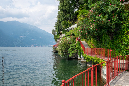 Walkway along Lake Como with red railing