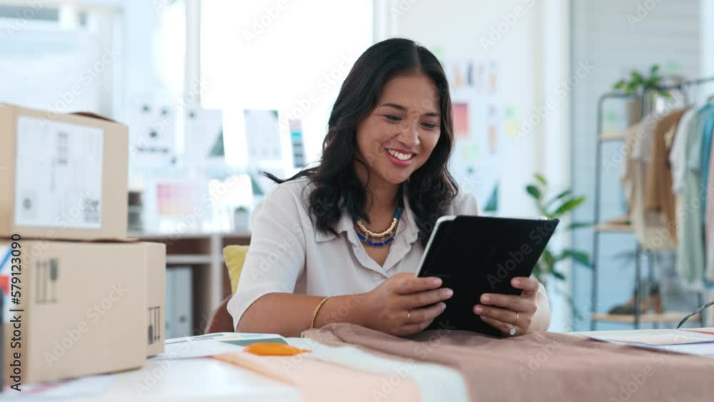 Indian woman, designer and tablet clothing design data check in a creative studio. Digital business work, happiness and textile employee working in a fabric workshop for stylist project with a smile Indian woman, designer and tablet clothing design data check in a creative studio. Digital business work, happiness and textile employee working in a fabric workshop for stylist project with a smile