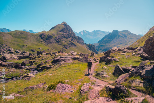 Traveler walking on path in mountains