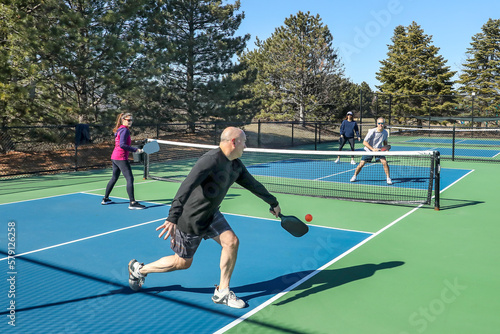 Men and Women in a Doubles Game of Pickleball photo