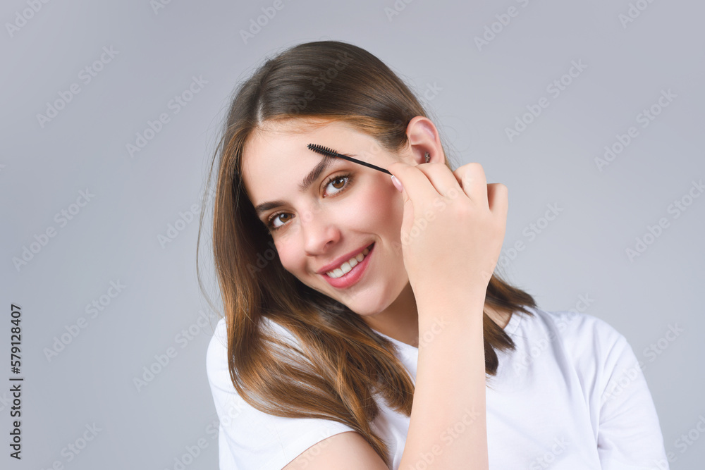 Woman shaping brown eyebrows. Woman eye with beautiful eyebrows. Shaped brows, long eyelashes. Paint eyebrows. Girl contouring eyebrows on isolated studio background. Woman shaping brown eyebrows. Woman eye with beautiful eyebrows. Shaped brows, long eyelashes. Paint eyebrows. Girl contouring eyebrows on isolated studio background.