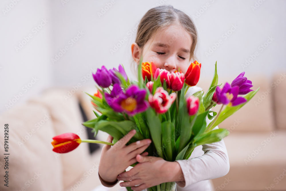 Little girl with spring tulip bouquet. Holiday decor with flowers colorful tulips. Little girl with spring tulip bouquet. Holiday decor with flowers colorful tulips.