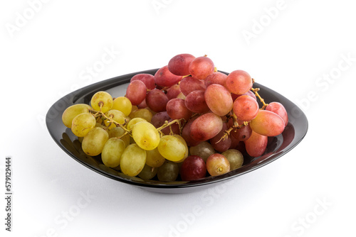 Delicious grapes on a black plate.