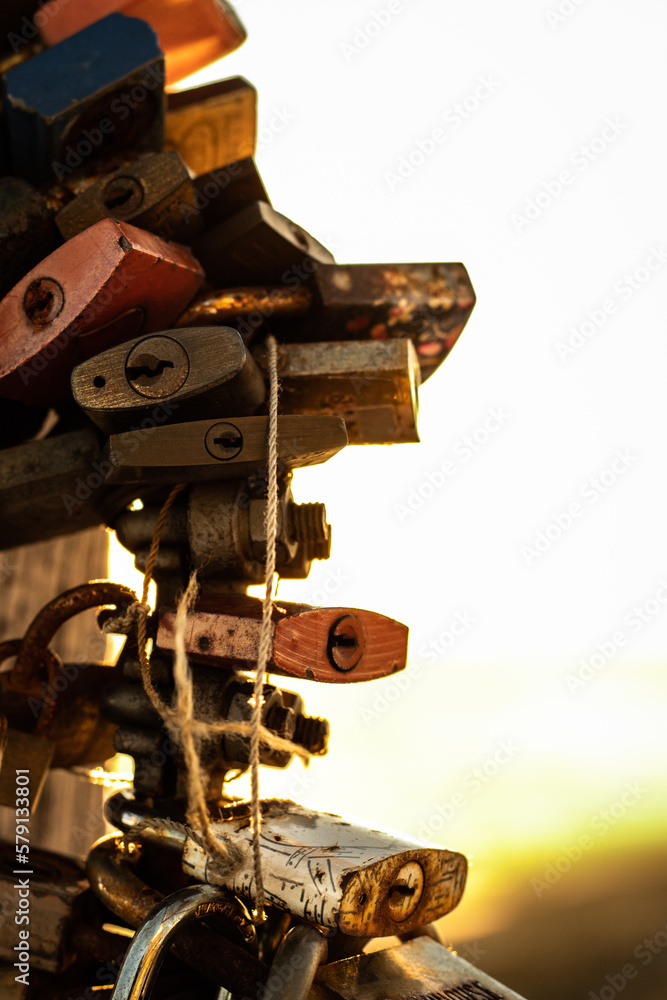 Fototapeta premium Locks of love attached to the cross on Jested at sunrise. Winter landscape in Liberec region.