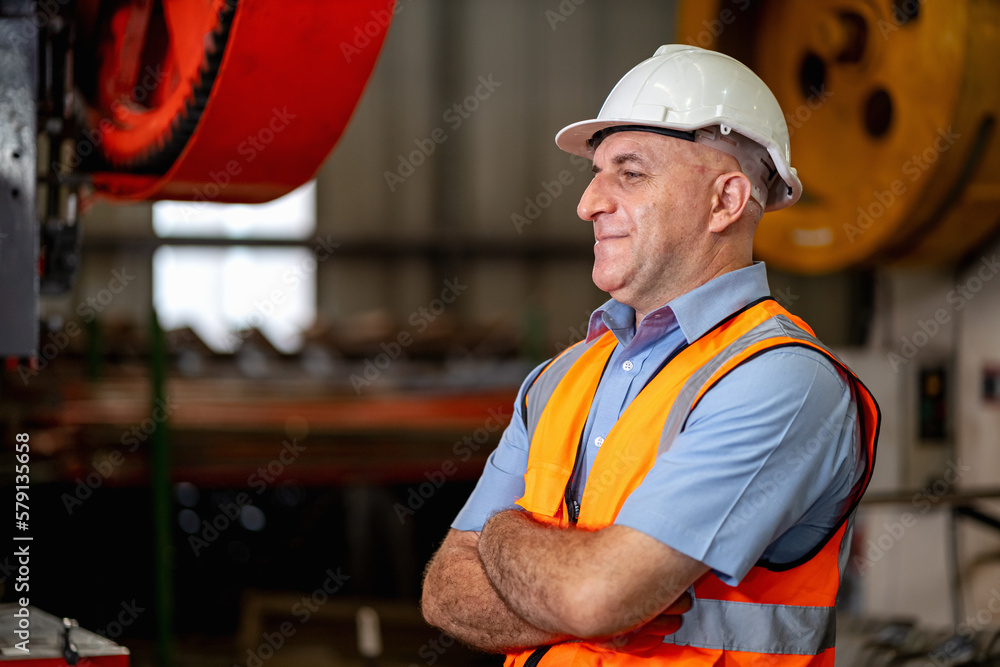 Smart portrait, male senior engineer standing with his arms crossed confidently.