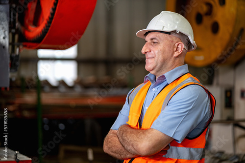 Smart portrait, male senior engineer standing with his arms crossed confidently.