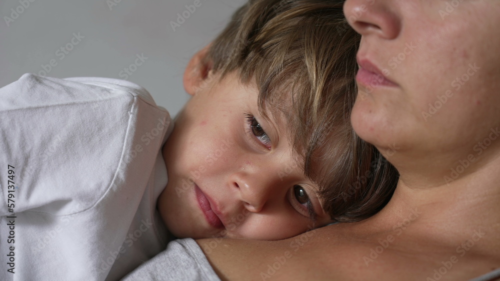 One thoughtful little boy leaning on mother chest. Pensive child close up face lying on parent body. Contemplative small boy resting with mom One thoughtful little boy leaning on mother chest. Pensive child close up face lying on parent body. Contemplative small boy resting with mom