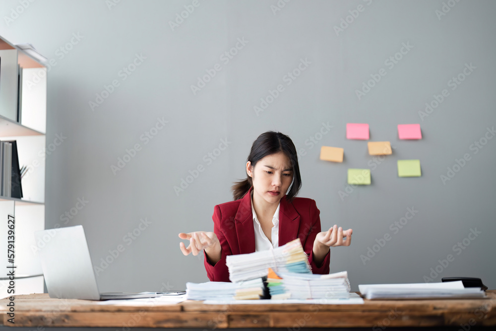 business woman sitting at work stressed , out working hard Feeling dizzy from job business woman sitting at work stressed , out working hard Feeling dizzy from job
