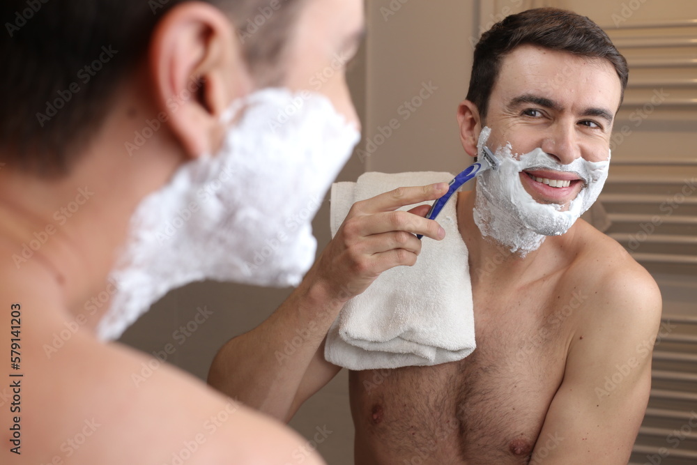 Man shaving manually in the bathroom 