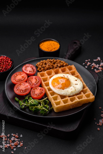 Delicious hearty breakfast consisting of a fried egg, Belgian waffle
