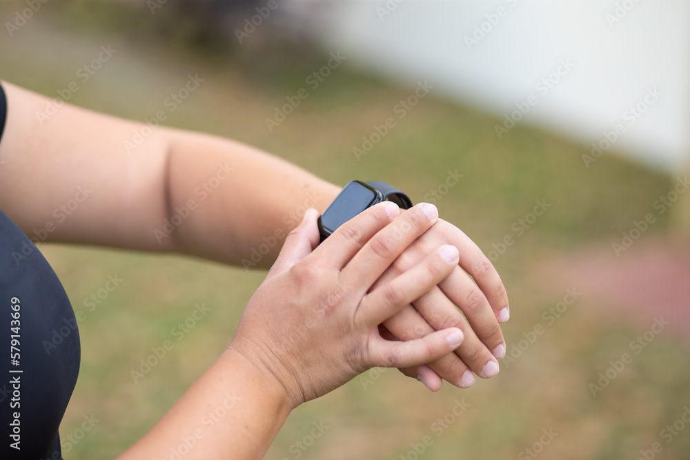 a couple of hands with a sport smartwach
