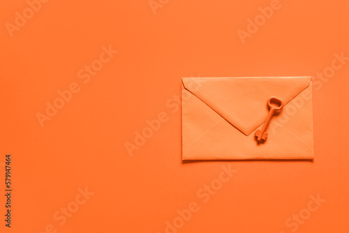 Fotografiet Envelope with key on orange background