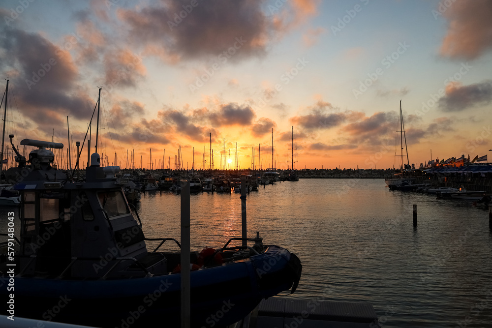 View of beautiful pier with yachts at sunset