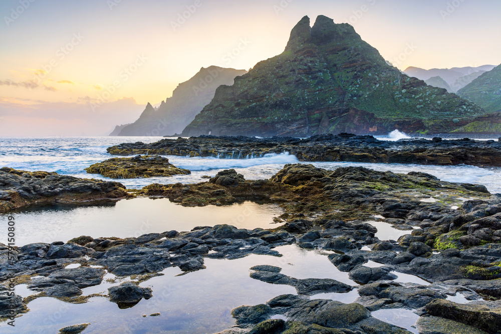 The rugged coastline of Punta del Hidalgo at sunrise, with the Anaga Mountains in the background, Tenerife, Canary Islands	
