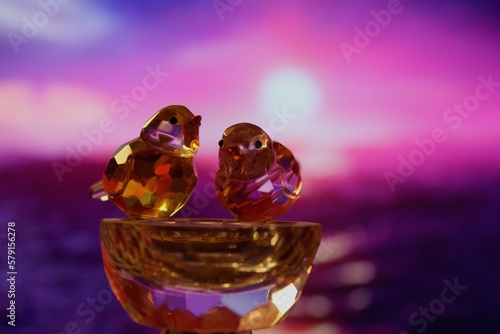 Crystal birds with bokeh sunset background